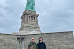 Work and travel student in front of Statue Of Liberty